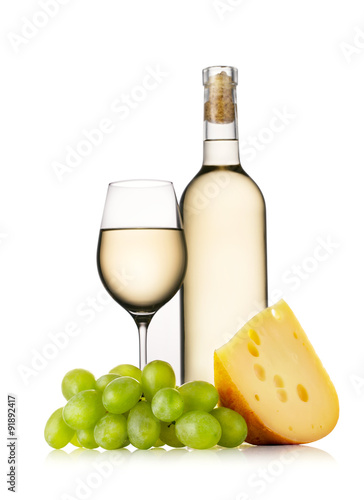 Glass and bottle of white wine with cheese