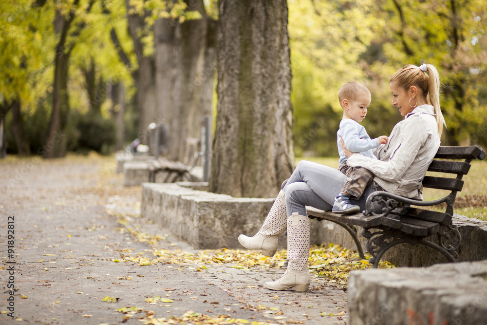 Fototapeta premium Mother and son in the autumn forest