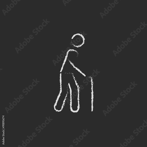 Man with cane icon drawn in chalk.
