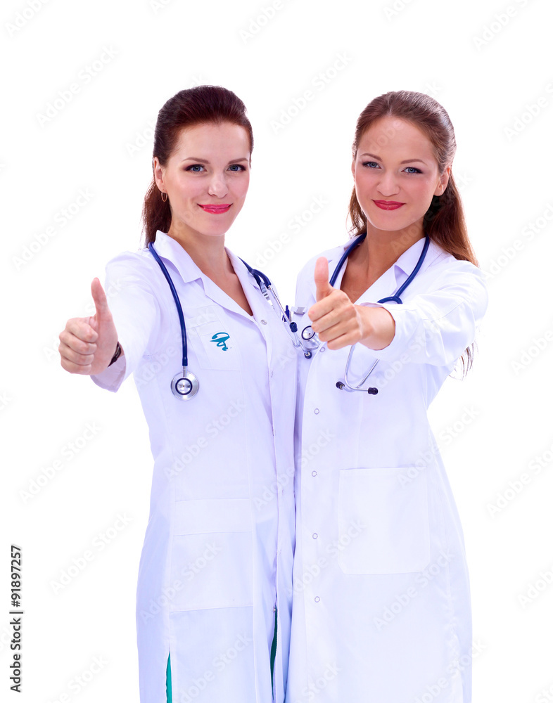 Two young woman doctor showing ok , standing in hospital Two young woman doctor showing ok , standing in hospital
