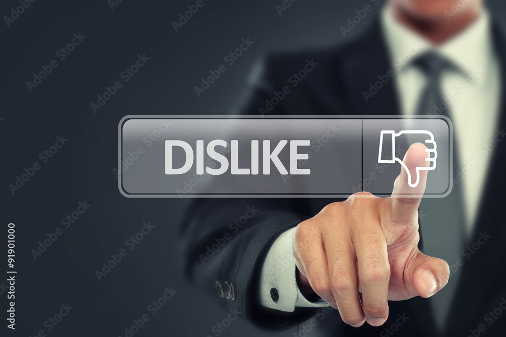 Businessman push to dislike button on virtual screen Businessman push to dislike button on virtual screen