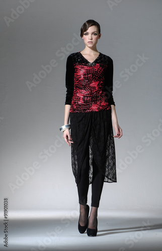 full-length portrait of Beautiful fashion model posing on gray background

