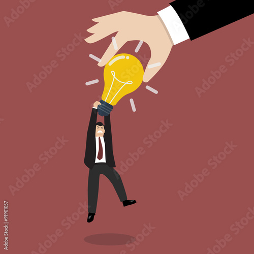 Hand stealing idea light bulb from businessman