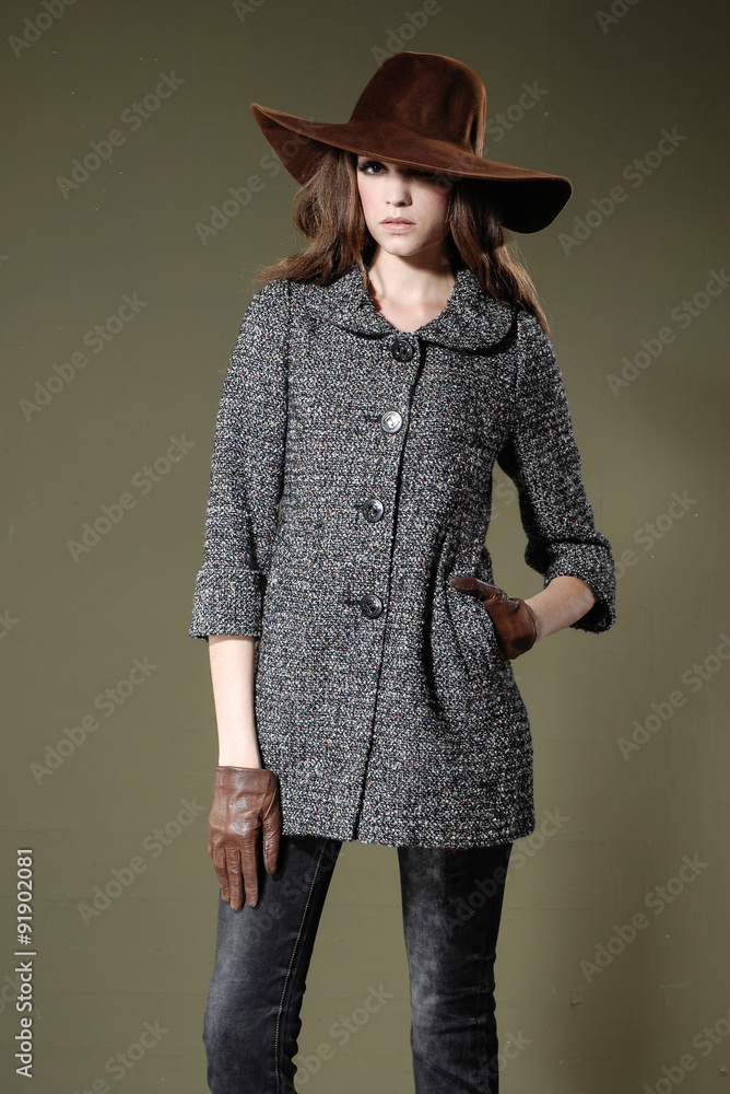 Portrait of young woman in hat posing in studio Portrait of young woman in hat posing in studio