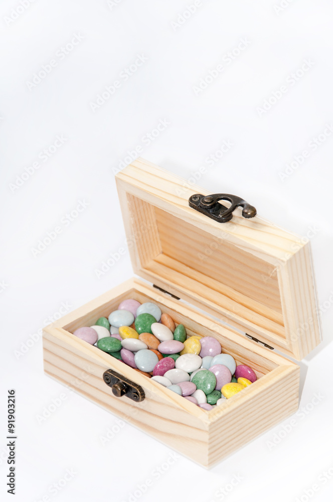 Wooden chest gift box with colorful round chocolates Wooden chest gift box with colorful round chocolates
