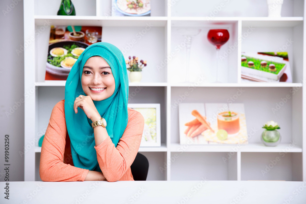 beautiful woman wearing hijab at living room with decorated back beautiful woman wearing hijab at living room with decorated back