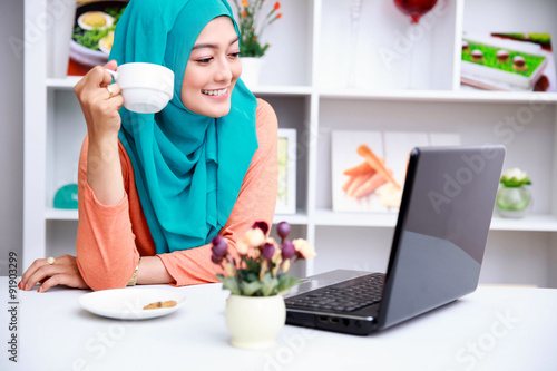 Wallpaper Mural young muslim woman enjoying morning day with a cup of tea and mo Torontodigital.ca