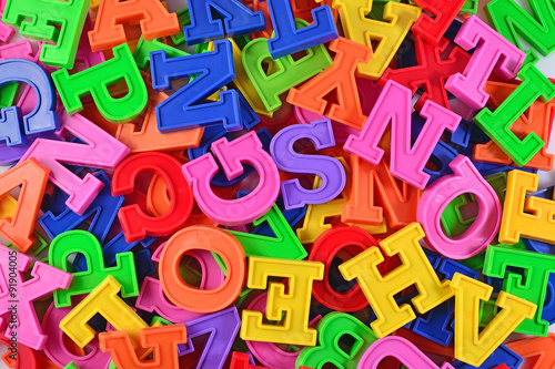 Colorful plastic alphabet letters as background