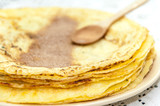Sugar with grounded cocoa on the pancakes
