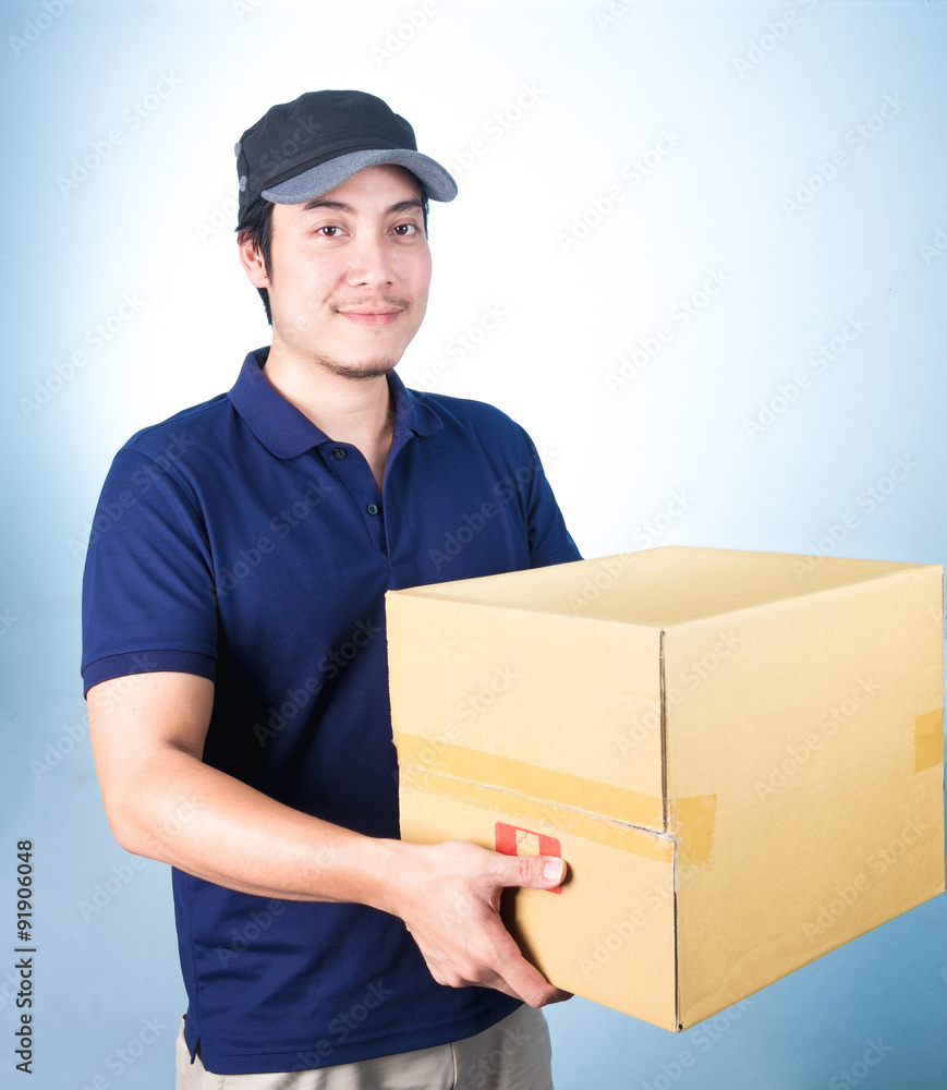 Smiling handsome asian delivery man giving and carrying parcel o Smiling handsome asian delivery man giving and carrying parcel o