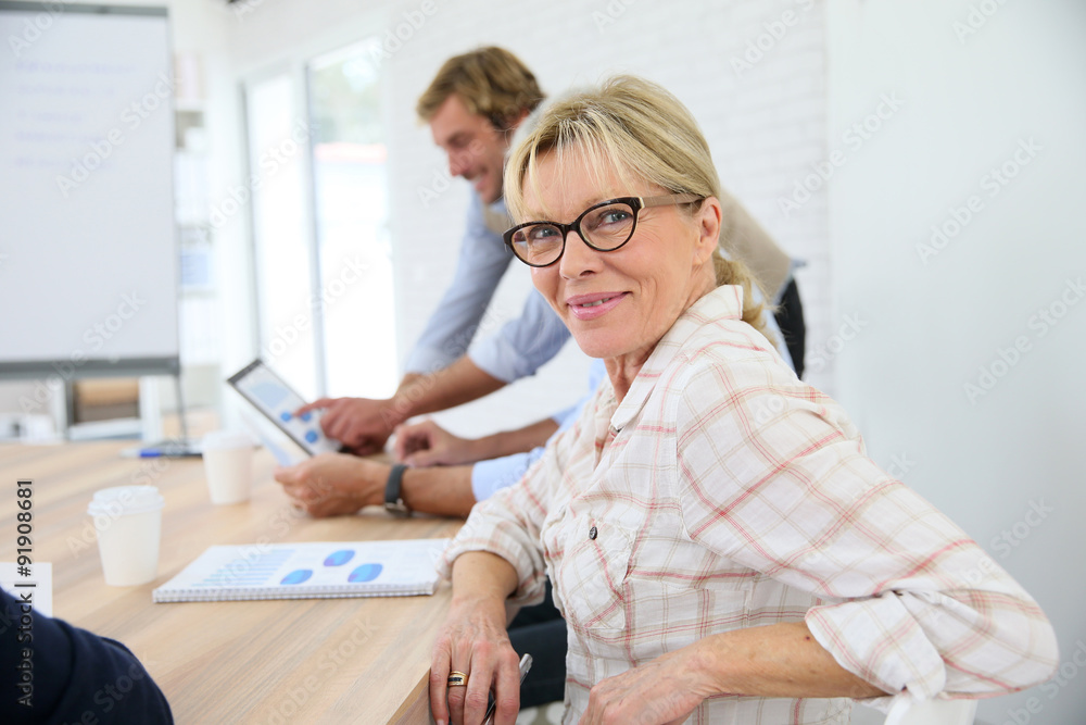 Portrait of senior woman attending business class Portrait of senior woman attending business class