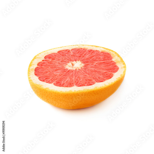 Single ripe grapefruit cut in half isolated over the white