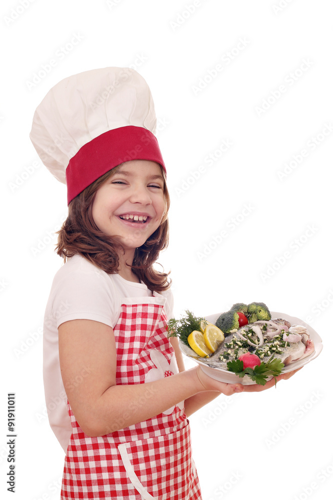 happy little girl cook with fresh trout on dish happy little girl cook with fresh trout on dish