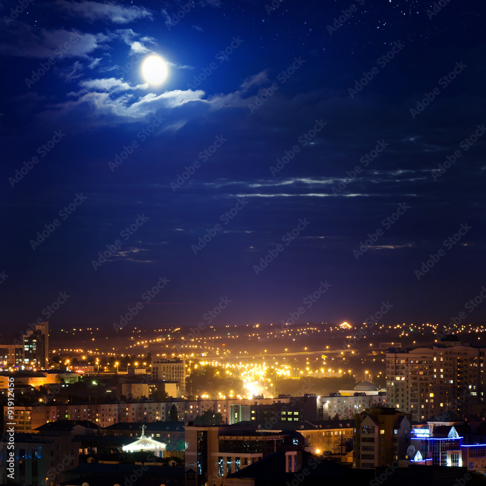 City landscape at nigh with sky filled with stars.