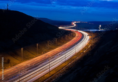 Light trails on the M62 motorway near Scammonden, Yorkshire, UK photo