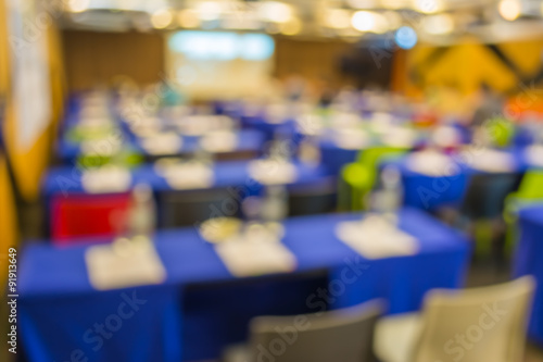 Blurred image of large seminar room .