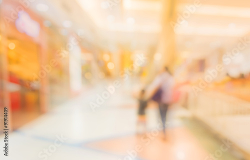blurred image of shopping mall and people . © coffmancmu