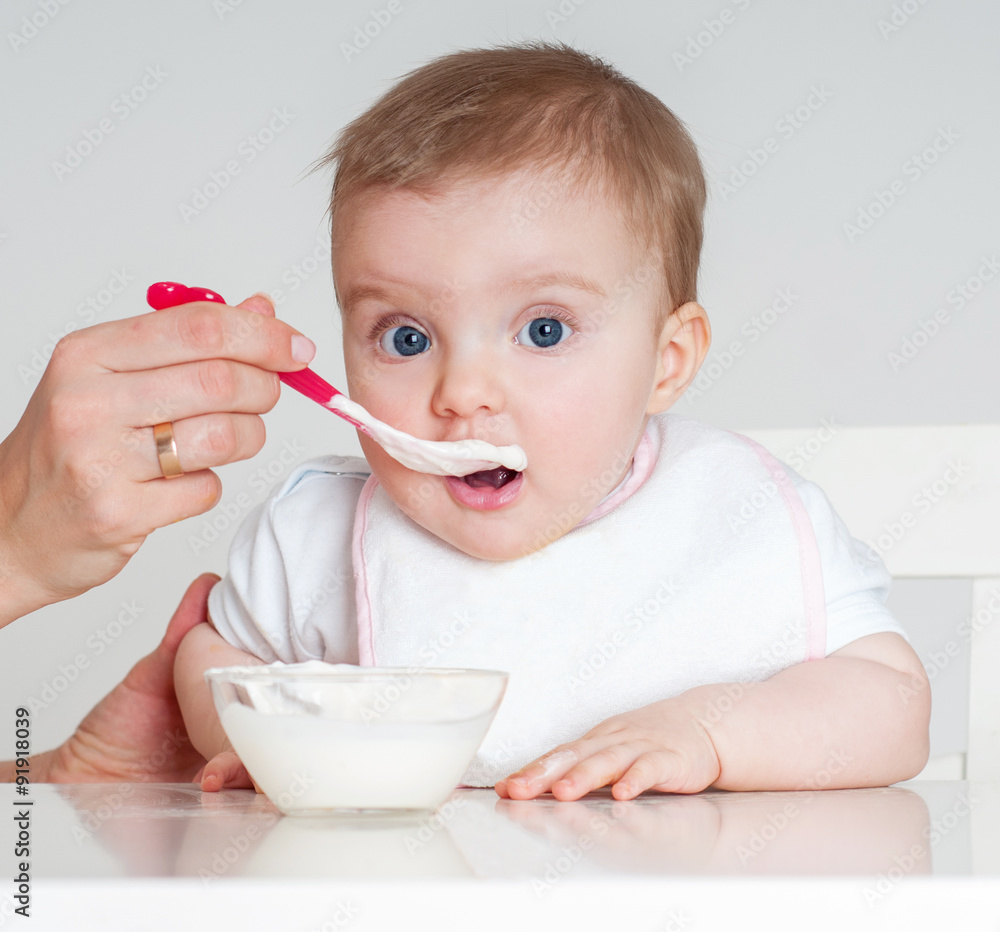Mother feeding baby with a spoon. Spoon-feed. Mother feeding baby with a spoon. Spoon-feed.