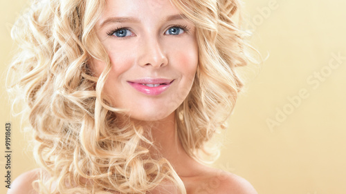 Blonde woman with perfect curly hair. Young woman with gorgeou
