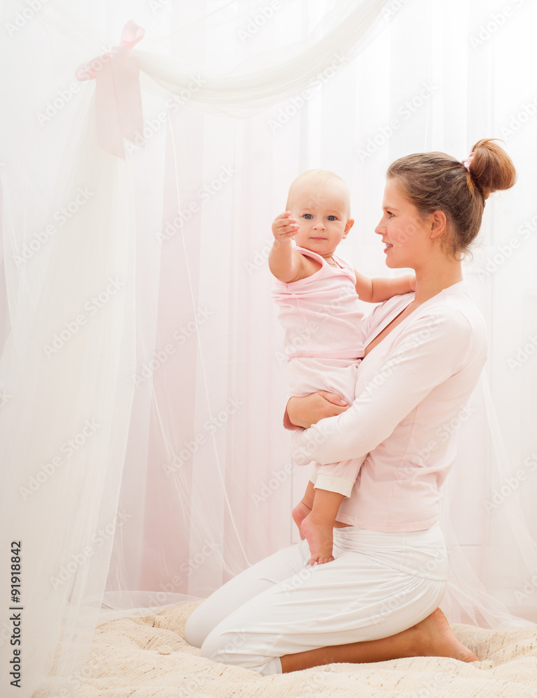 Mother and baby playing and smiling. Happy family.Home interior. Mother and baby playing and smiling. Happy family.Home interior.