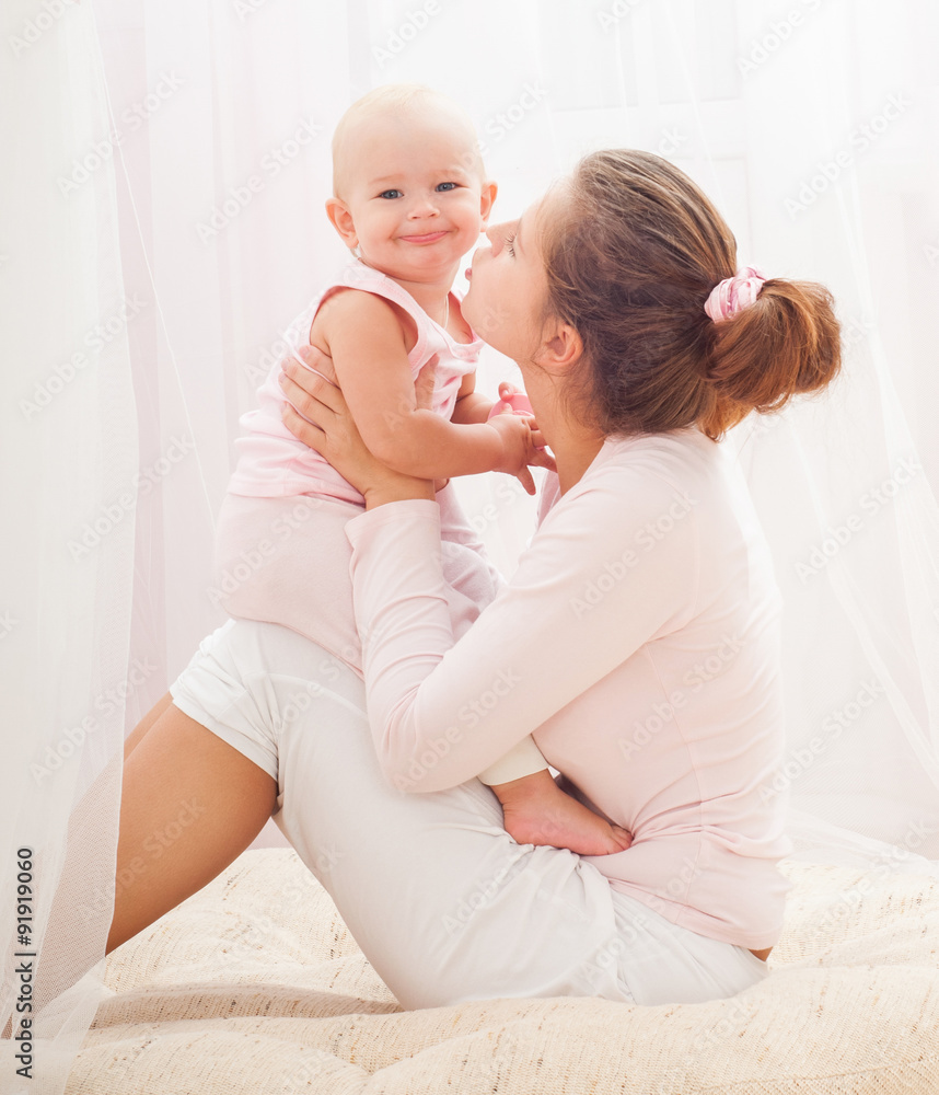 Mother and baby playing and smiling. Happy family.Home interior. Mother and baby playing and smiling. Happy family.Home interior.