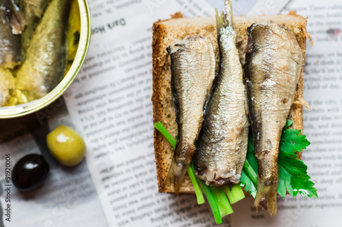 Sandwich with sardine on newspaper photo