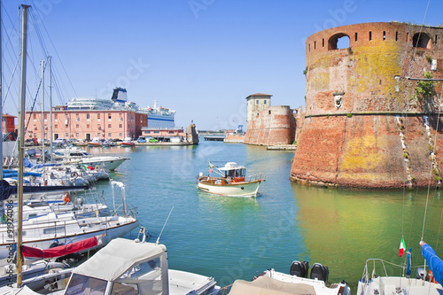 The Livorno's harbour with a ship sailing to the main Italian island photo