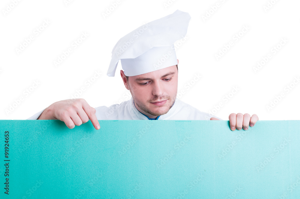 Cook or chef holding and showing green advertising space Cook or chef holding and showing green advertising space