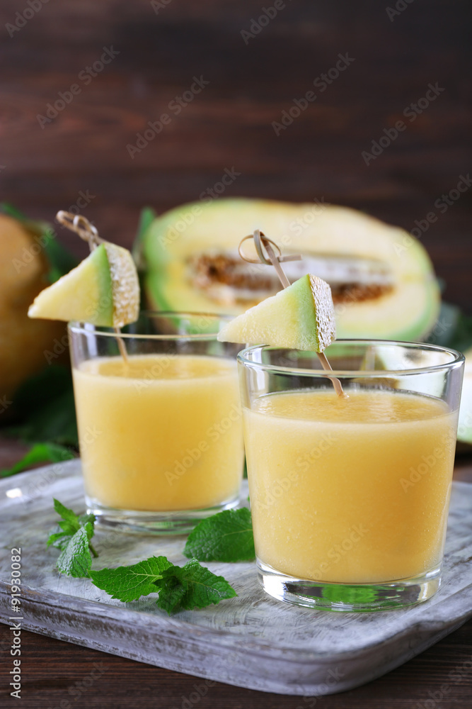 Glasses of melon cocktail on wooden background Glasses of melon cocktail on wooden background