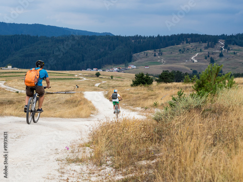 Kids riding mountain bikes in Rhodope Mountain, Bulgaria.
