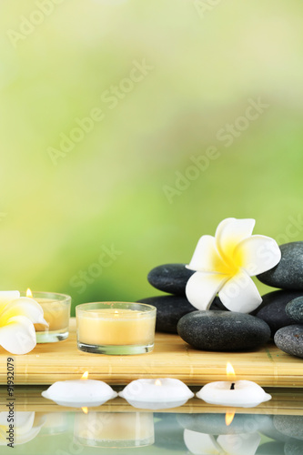 Still life with spa stones on light blurred background