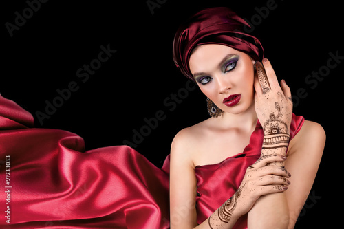 beautiful woman in oriental style with mehendi in hijab