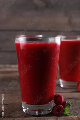 Berry cocktails and fresh berries on wooden background