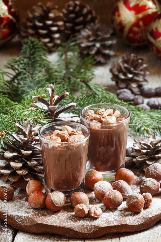 Festive chocolate mousse with nuts, decorated with pine cones an