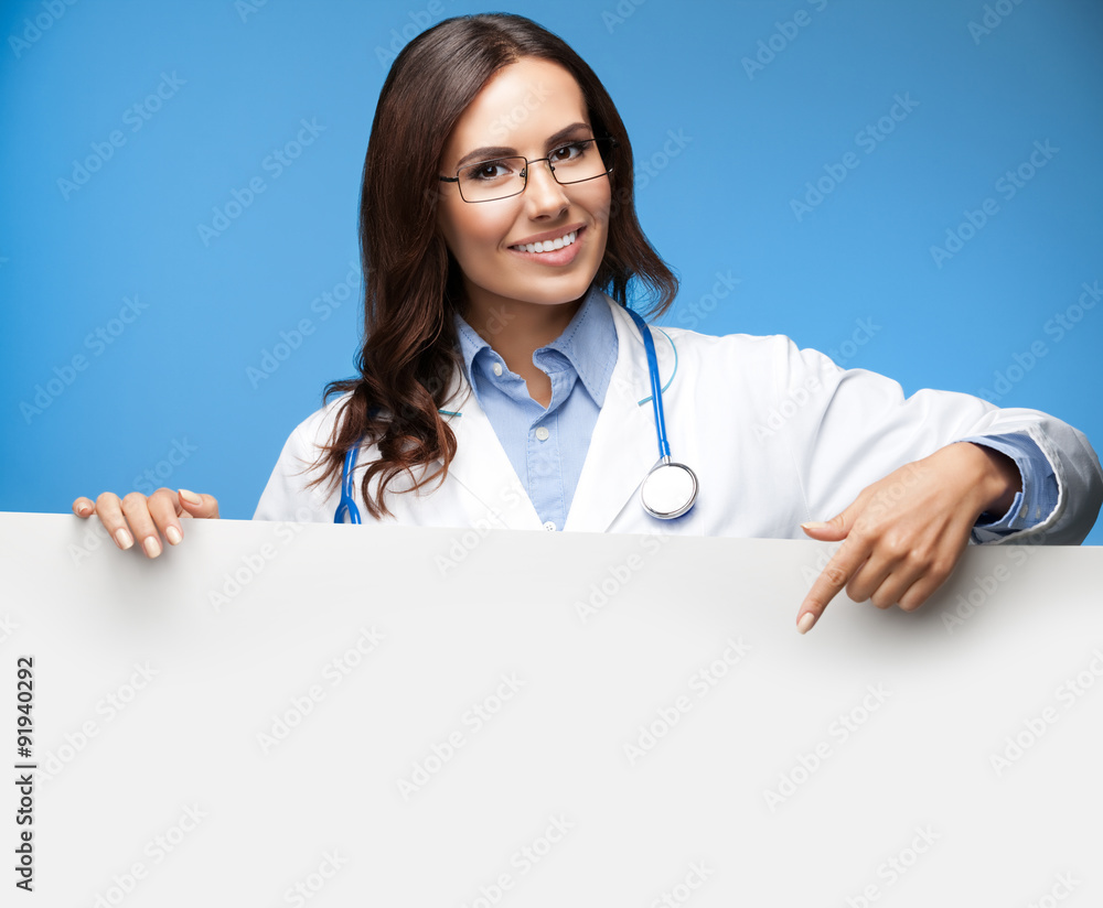 female doctor showing blank signboard, over blue female doctor showing blank signboard, over blue