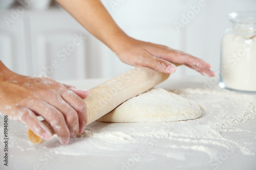 Making dough for apple pie by female hands at kitchen