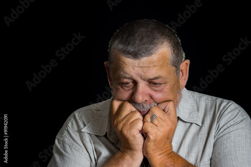 Portrait of senior man desperately thinking about life problems photo