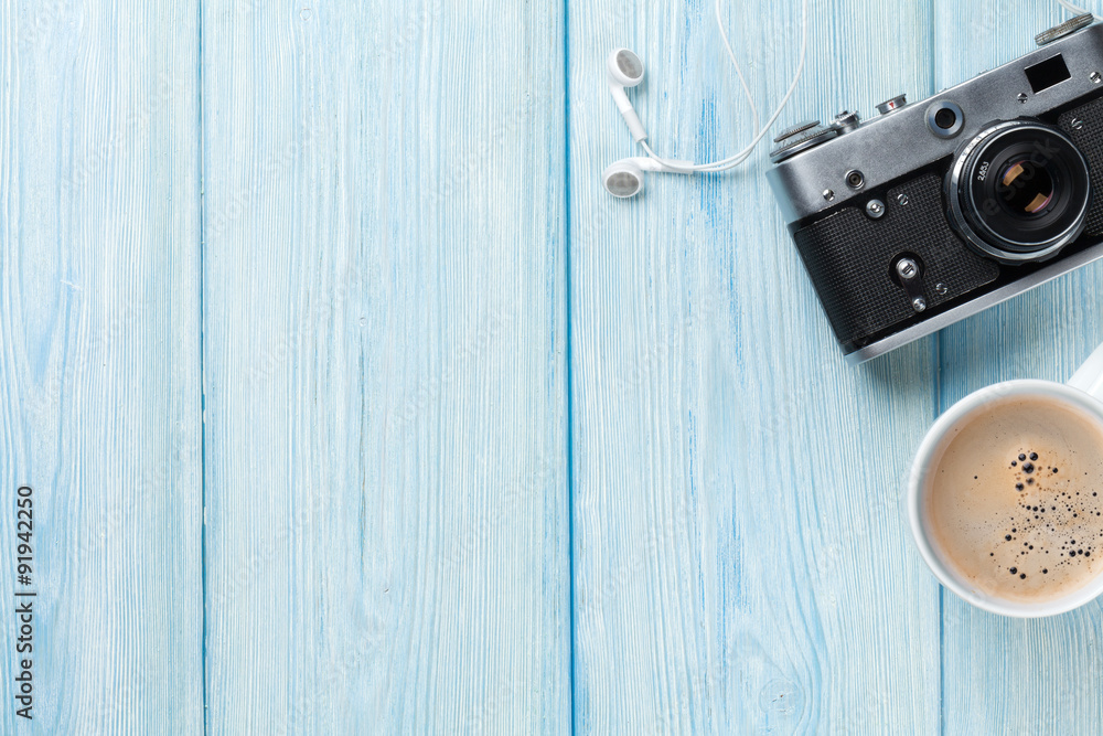 Travel camera and coffee cup on wooden table Travel camera and coffee cup on wooden table