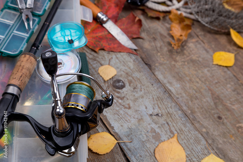 fishing tackles on board with leafs of autumn