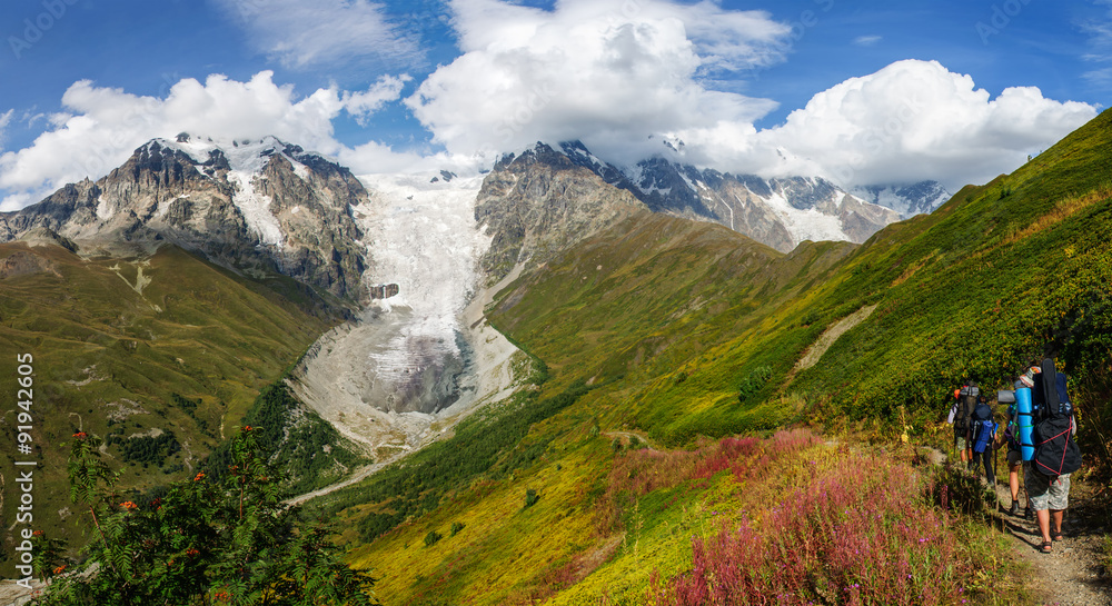 Fototapeta premium Tourists on beautiful glacier Ladaar landscape in Georgia.