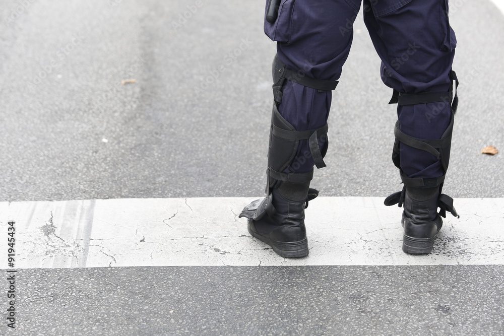 Police Officer in Tactical Boots with Protectors Police Officer in Tactical Boots with Protectors