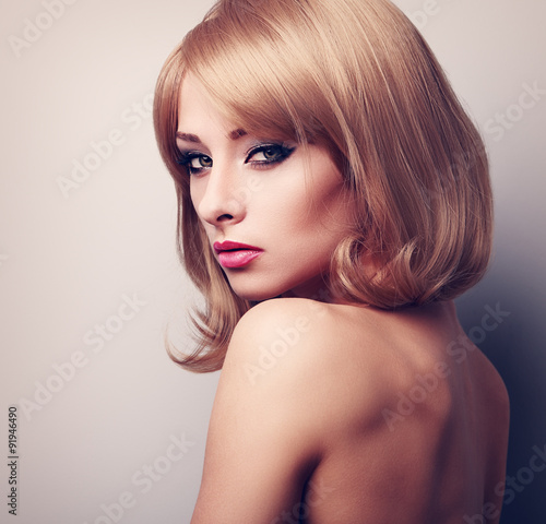 Sexy makeup female model with blond short hairstyle looking. Vin