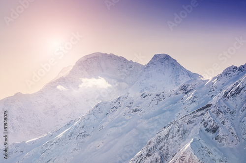 Winter snow-covered mountains at sunset