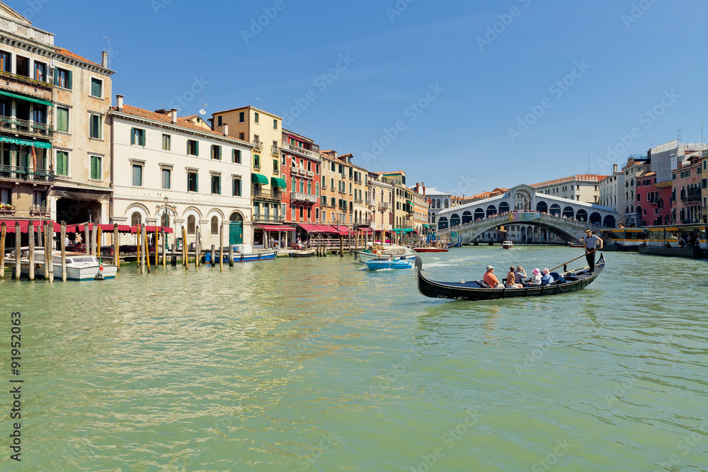 Grand Canal with traditional Gondola near famous Rialto bridge in Venice, Italy