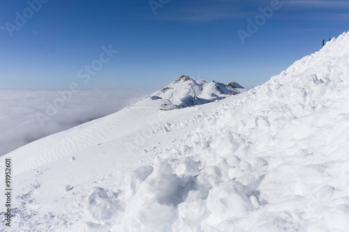 View on mountains and blue sky above clouds © Vasily Merkushev