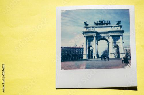 Instant photo on colored yellow background. Polaroid Milan