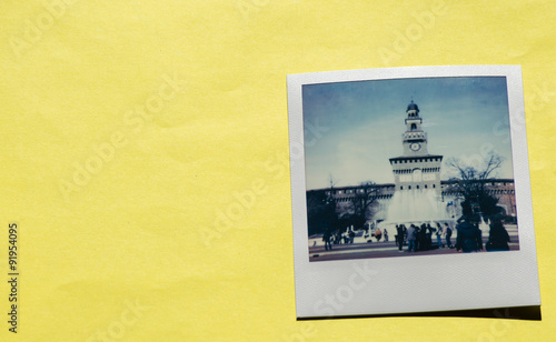 Instant photo on colored yellow background. Polaroid Milan