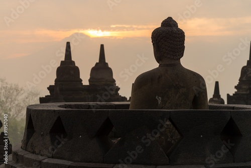 morning sunrise silhouette buddha sculpture in open stupa at Borobudur, Indonesia © tassapon