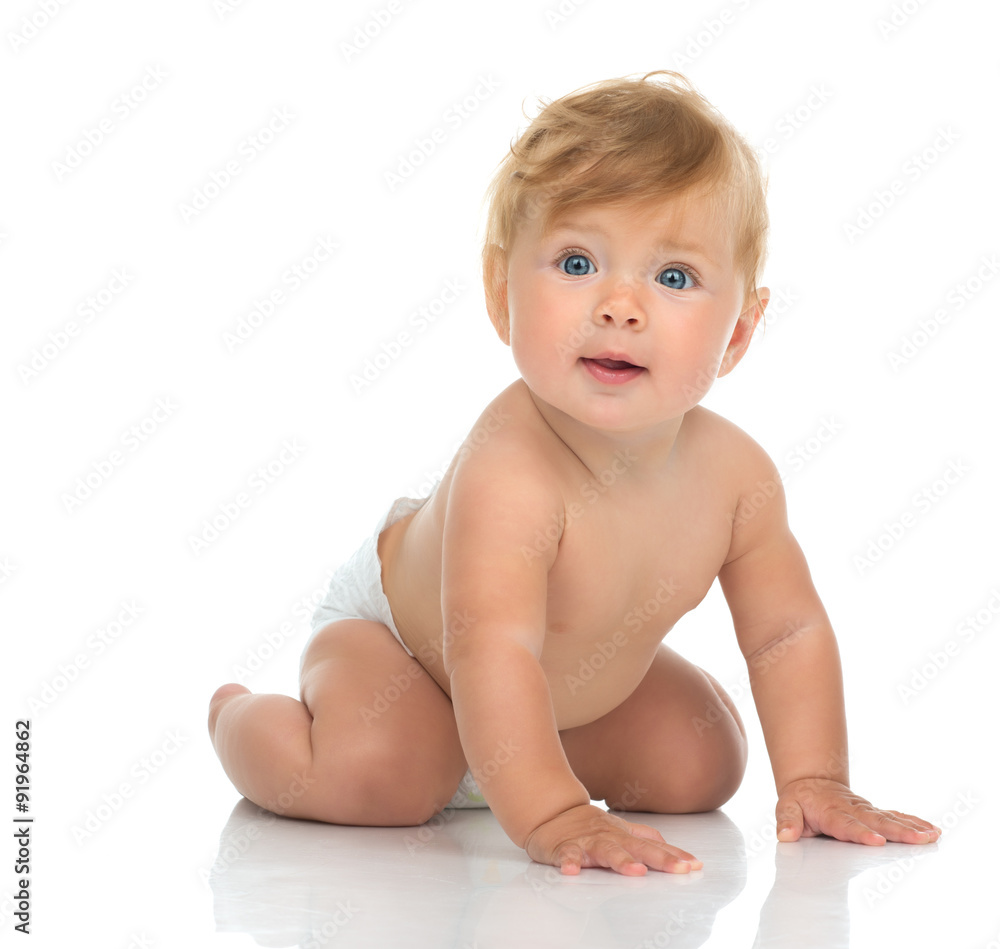 Infant child baby girl in diaper crawling happy looking at the c