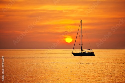 Yacht in the sea at sunset